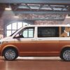 Custom window decals featuring artistic designs on a Volkswagen Transporter